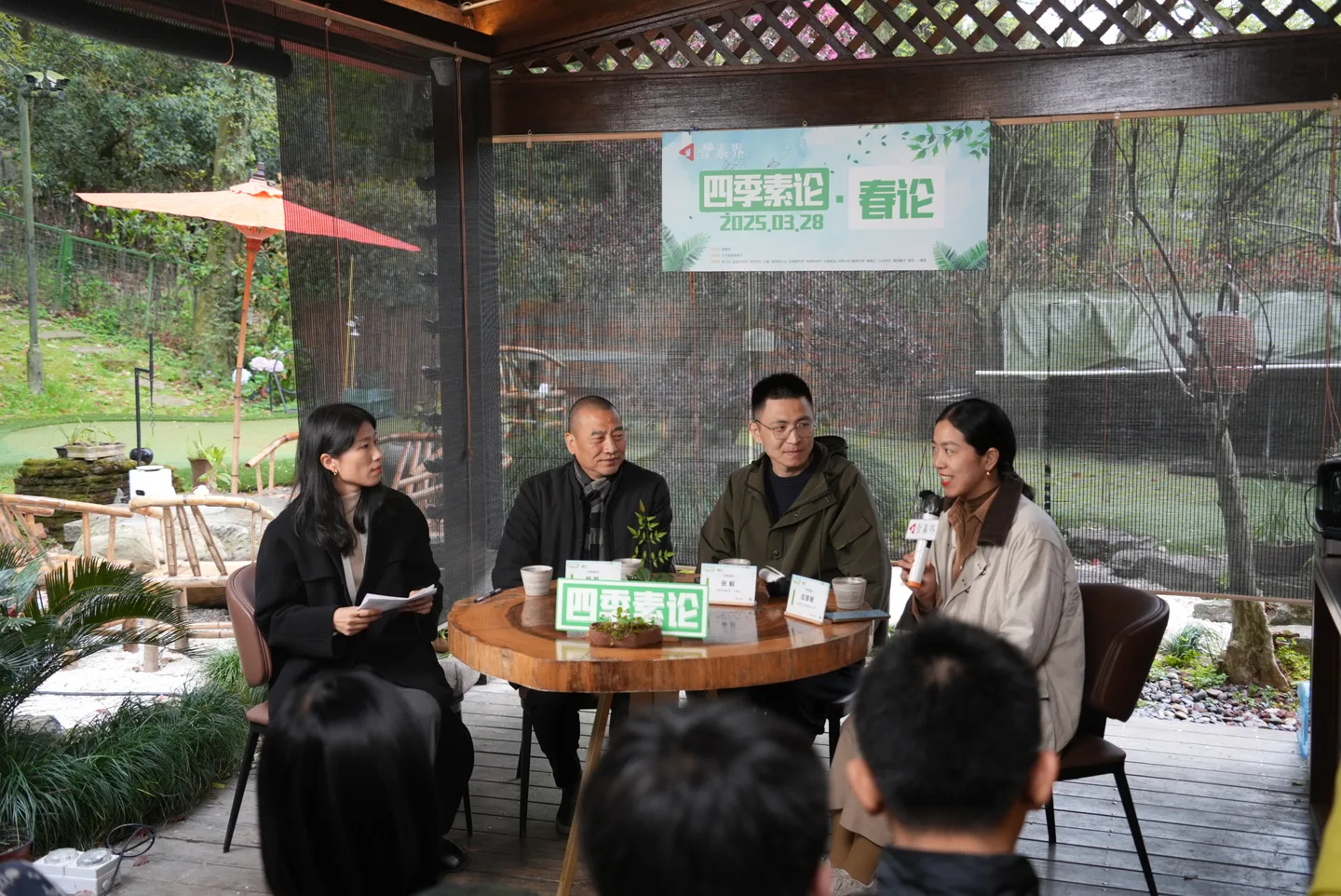 Four participants in a round-table conversation beneath the 四季素论 spring forum banner.