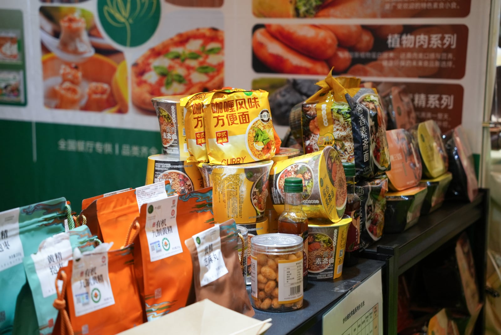 Packaged noodles, jars and other food products arranged on an exhibition display counter.